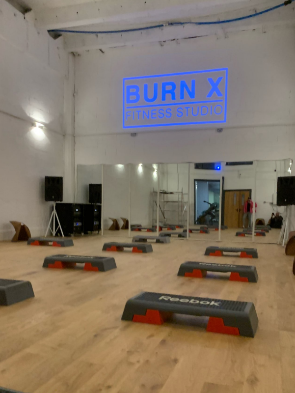 gobo lights show the gym fitness studio brand name in dark blue
